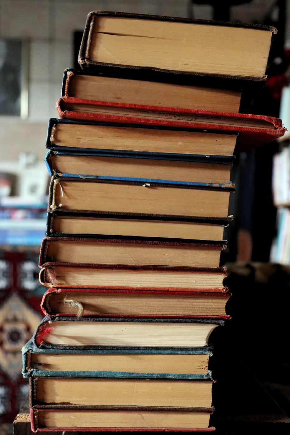 A tall stack of old clothbound books